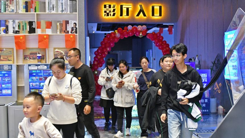 People walk inside a cinema in the Fushan district of Yantai city, Shandong province, on October 7, 2024.