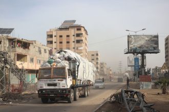 A truck carrying humanitarian aid drives in central Gaza.