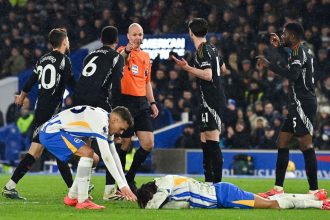 Brighton's Brazilian striker João Pedro reacts following the foul as referee Anthony Taylor gives a penalty to Brighton.