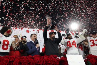 Head coach Ryan Day of the Ohio State Buckeyes holds up the Leishman Trophy after defeating the Oregon Ducks in the Rose Bowl in Pasadena, California on January 1.