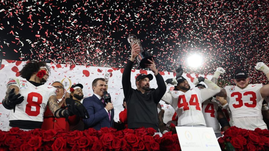 Head coach Ryan Day of the Ohio State Buckeyes holds up the Leishman Trophy after defeating the Oregon Ducks in the Rose Bowl in Pasadena, California on January 1.