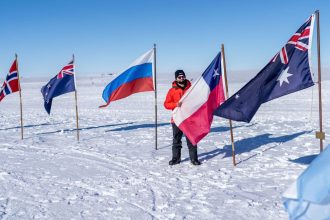 Chilean President Gabriel Boric displays his country's flag at the South Pole in a photo posted to his X account.