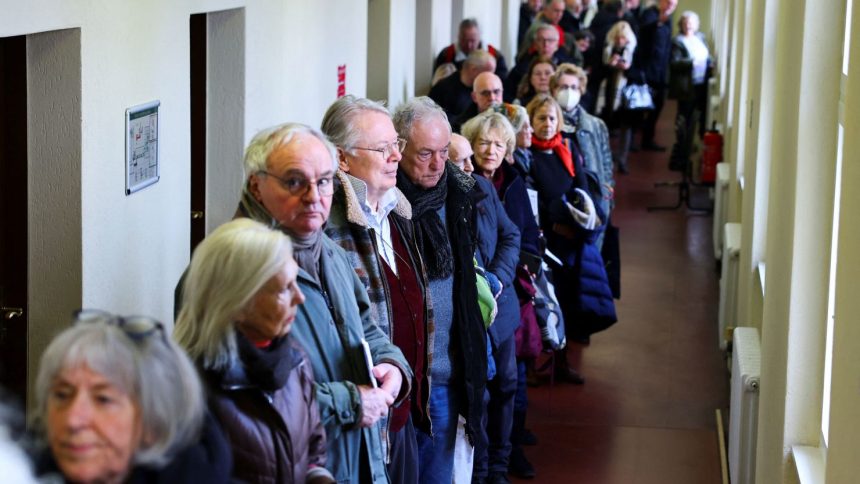 People queue to vote in an advanced postal ballot for the upcoming general elections at Steglitz-Zehlendorf district postal ballot polling station, in Berlin, Germany, on February 10, 2025.