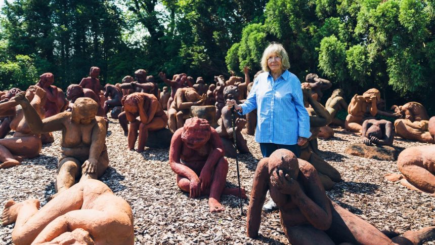 Suse Lowenstein with her sculptural installation, Dark Elegy, which sits in her yard in Montauk, New York.