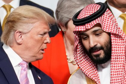 President Donald Trump speaks with Saudi Arabia's Crown Prince Mohammed bin Salman during family photo session with other leaders and attendees at the G20 leaders summit in Osaka, Japan, June 28, 2019.