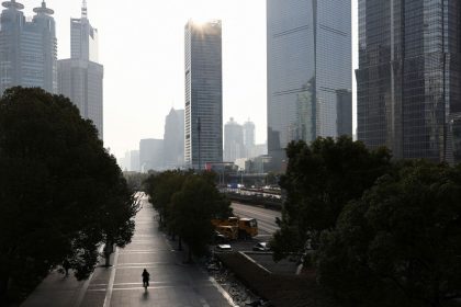 A person rides a bicycle in the Pudong financial district of Shanghai, China, on February 5, 2025.