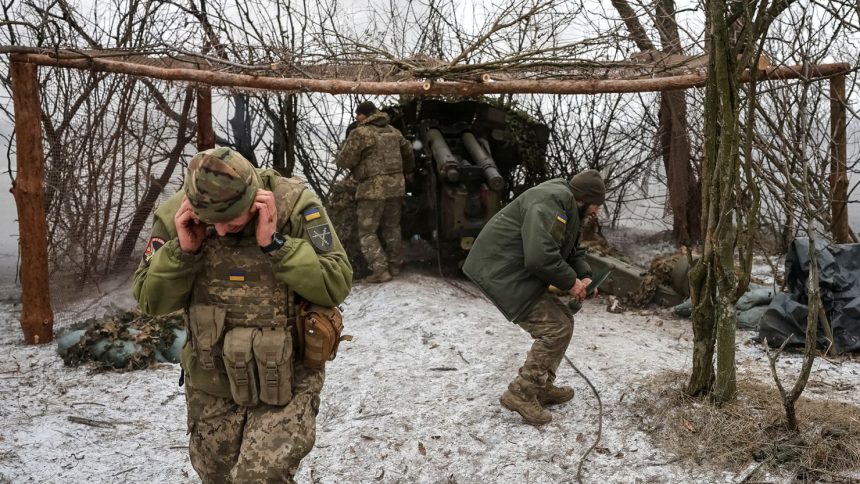 Ukrainian troops fire a howitzer toward Russian positions near Pokrovsk, Donetsk region, Ukraine, February 6, 2025.