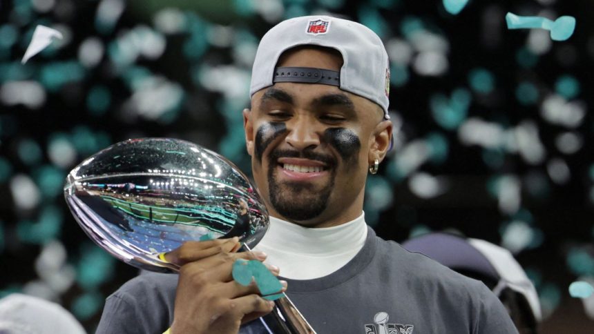 Philadelphia Eagles QB Jalen Hurts celebrates with the Vince Lombardi Trophy after winning the Super Bowl.