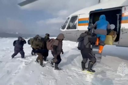 Fishermen stranded on an ice floe in the Sea of Okhotsk board a helicopter during a rescue operation in the Sakhalin region, Russia, February 12, in this still image taken from video.