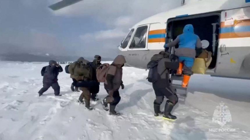 Fishermen stranded on an ice floe in the Sea of Okhotsk board a helicopter during a rescue operation in the Sakhalin region, Russia, February 12, in this still image taken from video.