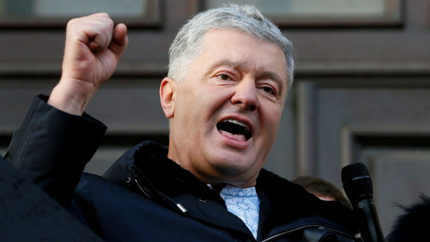 Ukraine's former president Petro Poroshenko greets his supporters outside a court building after a hearing in Kyiv in 2022.