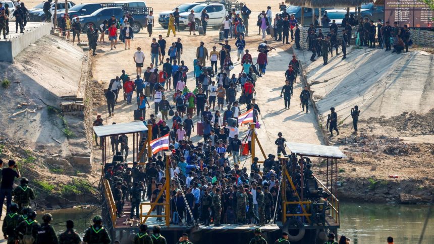 Multinational victims of scam centers, who were tricked or trafficked into working in Myanmar, walk towards a vessel in order to cross Moei River to Thailand, in Phop Phra District, Tak province, Thailand, on February 12, 2025.