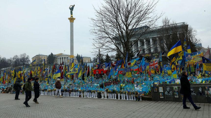 People visit a makeshift memorial for fallen Ukrainian soldiers during Russia's war on Ukraine at Independence Square in Kyiv in February 2025.