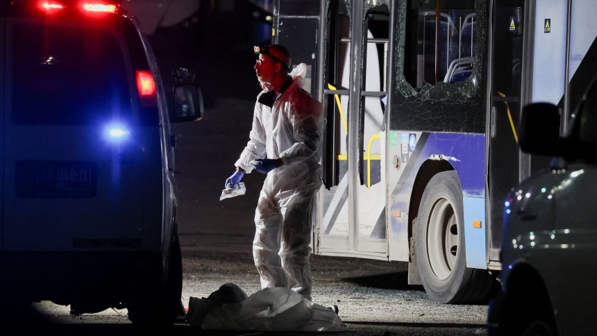 Forensic personnel inspect the area where a bus exploded, in Bat Yam, south of Tel Aviv, Israel.