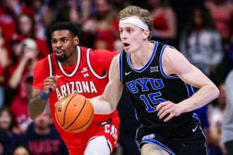 BYU guard Richie Saunders (No. 15) hit two late free throws to help the Cougars record a famous victory over the No. 19 Arizona Wildcats.