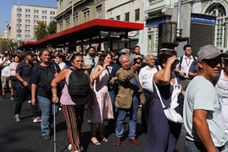 People stand outside buildings after a large power outage struck vast swaths of the country, in Santiago, Chile February 25, 2025. REUTERS/Pablo Sanhueza