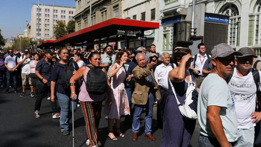 People stand outside buildings after a large power outage struck vast swaths of the country, in Santiago, Chile February 25, 2025. REUTERS/Pablo Sanhueza