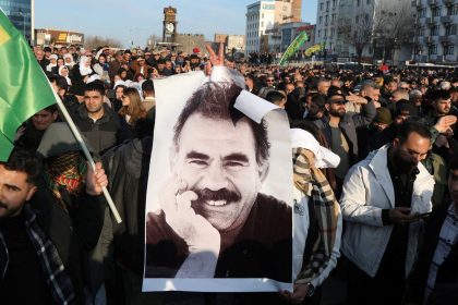 A demonstrator holds a picture of jailed Kurdish militant leader Abdullah Ocalan during a rally in Diyarbakir, Turkey on Thursday.