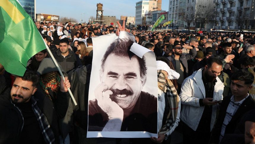 A demonstrator holds a picture of jailed Kurdish militant leader Abdullah Ocalan during a rally in Diyarbakir, Turkey on Thursday.