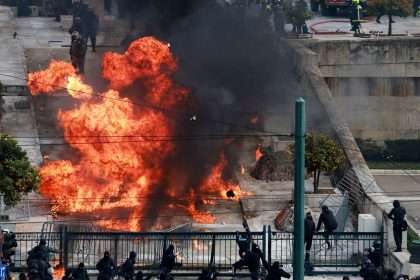 People gather next to fire during clashes, near the Greek parliament at a protest, marking the second anniversary of the country's worst railway disaster in Athens, Greece, February 28, 2025.