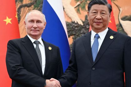 This pool photograph distributed by Russian state owned agency Sputnik shows Russia's President Vladimir Putin and Chinese President Xi Jinping shaking hands during a meeting in Beijing on October 18, 2023.