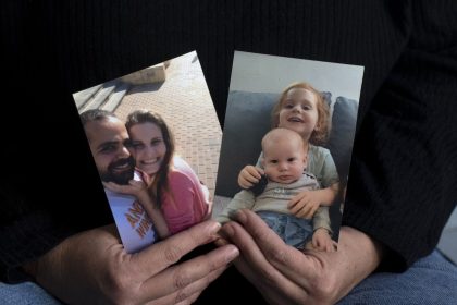 Yifat Zailer shows photos of her cousin, Shiri Bibas (center) her husband Yarden (left) and their sons Ariel (top right) and Kfir, who were taken hostage by Hamas militants, at her home in Herziliyya, Israel on January 15.