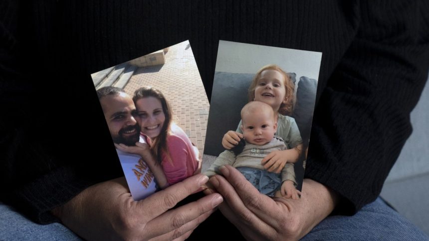 Yifat Zailer shows photos of her cousin, Shiri Bibas (center) her husband Yarden (left) and their sons Ariel (top right) and Kfir, who were taken hostage by Hamas militants, at her home in Herziliyya, Israel on January 15.