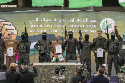 Former Israeli hostages Ohad Ben Ami, Eli Sharabi and Or Levy are escorted by Hamas fighters before being handed over to the Red Cross in Deir al-Balah, Gaza, last Saturday.