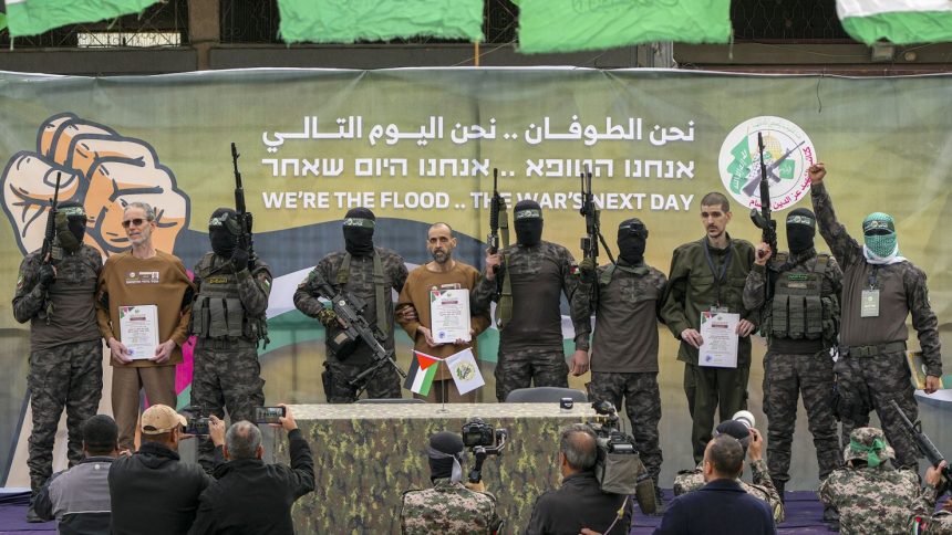 Former Israeli hostages Ohad Ben Ami, Eli Sharabi and Or Levy are escorted by Hamas fighters before being handed over to the Red Cross in Deir al-Balah, Gaza, last Saturday.