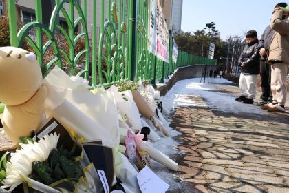 People mourn the death of a pupil stabbed to death allegedly by a teacher, outside of an elementary school in Daejeon, South Korea, on Tuesday, February 11, 2025.