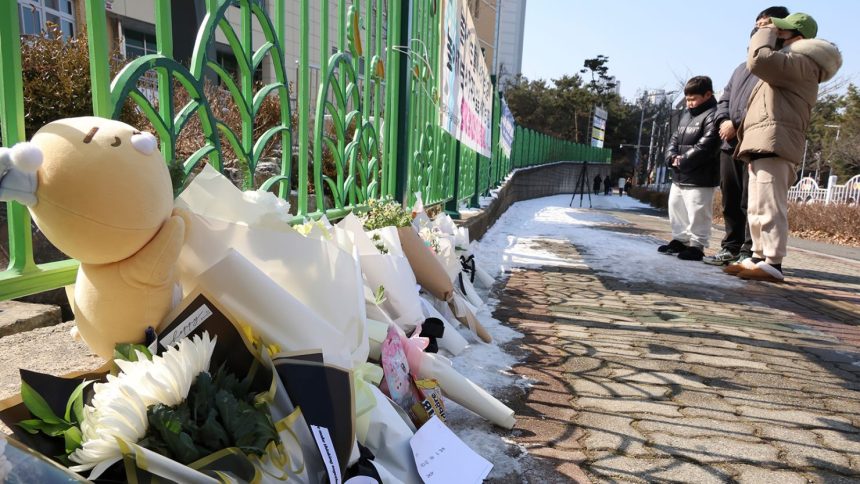 People mourn the death of a pupil stabbed to death allegedly by a teacher, outside of an elementary school in Daejeon, South Korea, on Tuesday, February 11, 2025.