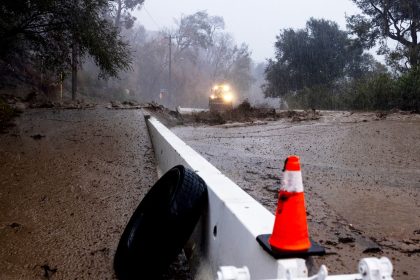 A road is covered in mud in the Eaton Fire zone during a storm Thursday in Altadena, California.