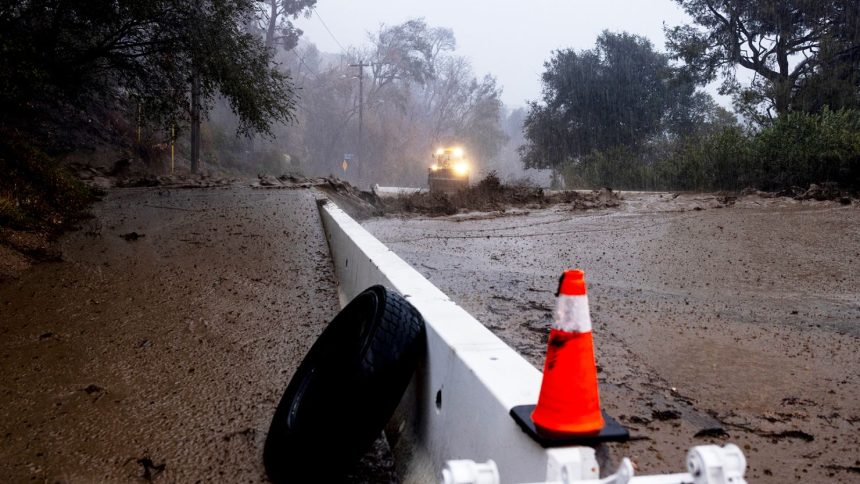 A road is covered in mud in the Eaton Fire zone during a storm Thursday in Altadena, California.