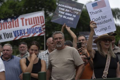 White South Africans demonstrate in support of U.S. President Donald Trump in front of the U.S. embassy in Pretoria, South Africa, Saturday, Feb. 15, 2025.