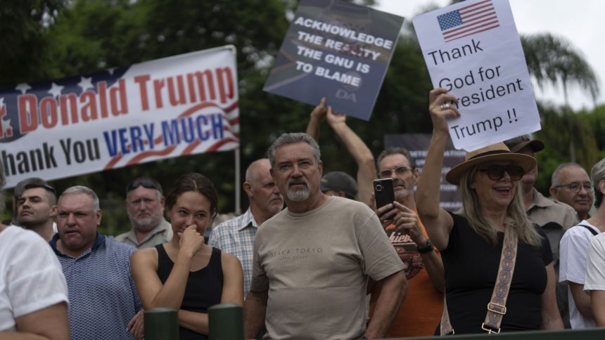 White South Africans demonstrate in support of U.S. President Donald Trump in front of the U.S. embassy in Pretoria, South Africa, Saturday, Feb. 15, 2025.