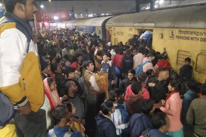 Passengers jostle to board a train at the railway station in New Delhi, India, on Feb.15, 2025.