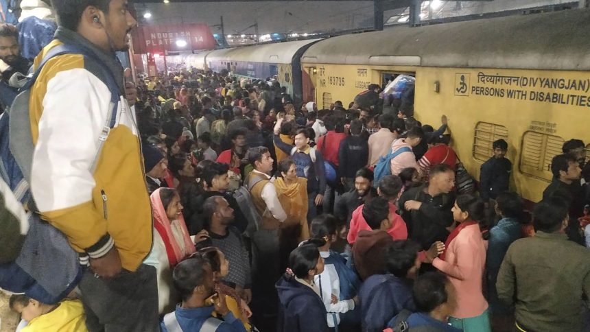 Passengers jostle to board a train at the railway station in New Delhi, India, on Feb.15, 2025.