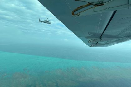 A Chinese military helicopter flies close to a Philippine Bureau of Fisheries and Aquatic aircraft, above Scarborough Shoal in the South China Sea on Tuesday, February 18, 2025.