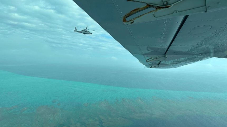 A Chinese military helicopter flies close to a Philippine Bureau of Fisheries and Aquatic aircraft, above Scarborough Shoal in the South China Sea on Tuesday, February 18, 2025.