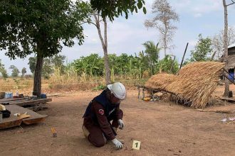 This photo provided by Cambodia Mine Action Center shows a deminer from the Cambodia Mine Action Center inspecting fragments of a decades-old rocket-propelled grenade that killed two toddlers when it exploded in Kranhuong village in Siem Reap province’s Svay Leu district in Cambodia, on February 22, 2025.