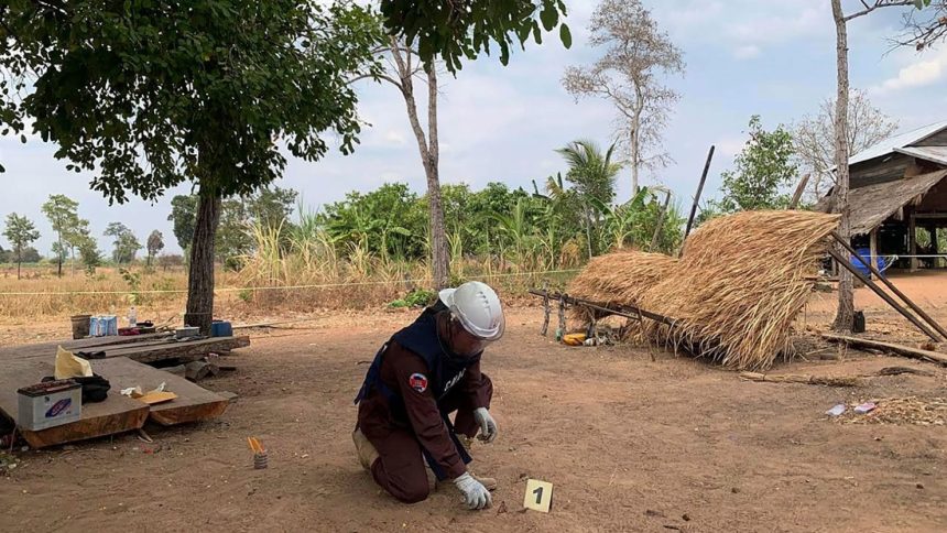 This photo provided by Cambodia Mine Action Center shows a deminer from the Cambodia Mine Action Center inspecting fragments of a decades-old rocket-propelled grenade that killed two toddlers when it exploded in Kranhuong village in Siem Reap province’s Svay Leu district in Cambodia, on February 22, 2025.