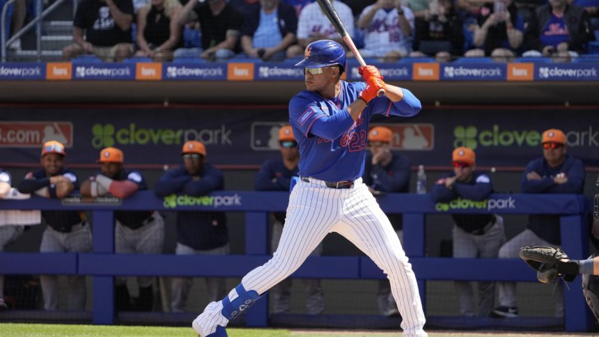 New York Mets' Juan Soto bats during the first inning of a spring training baseball game against the Houston Astros Saturday, Feb. 22, 2025, in Port St. Lucie, Fla. (AP Photo/Jeff Roberson)