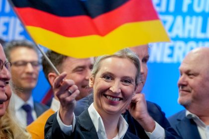 AfD co-leader Alice Weidel waves a German flag at the party's headquarters after the elections on Sunday in Berlin.