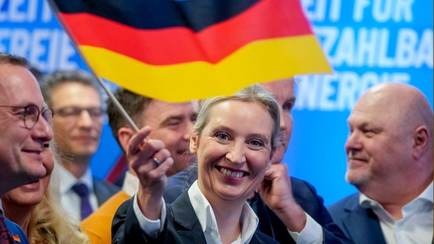 AfD co-leader Alice Weidel waves a German flag at the party's headquarters after the elections on Sunday in Berlin.