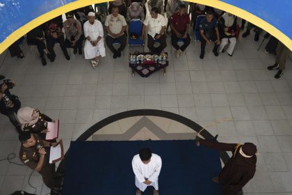 A Shariah Law official uses a rattan cane to whip one of two men convicted of gay sex in Banda Aceh, Aceh province, Indonesia, Thursday, Feb. 27, 2025.