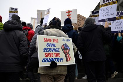 People rally at Health and Human Services headquarters to protest the polices of President Donald Trump and Elon Musk on Wednesday, February 19 in Washington, DC.