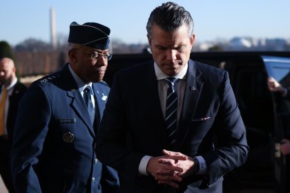 Secretary of Defense Pete Hegseth, right, arrives at the Pentagon and is greeted by Chairman of the Joint Chiefs of Staff Gen. CQ Brown, left, on January 27, in Arlington, Virginia.