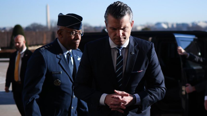 Secretary of Defense Pete Hegseth, right, arrives at the Pentagon and is greeted by Chairman of the Joint Chiefs of Staff Gen. CQ Brown, left, on January 27, in Arlington, Virginia.