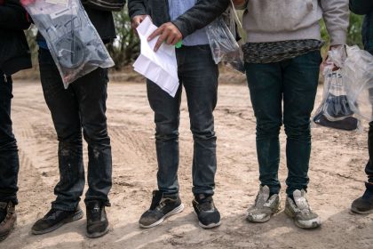 Unaccompanied minors await Border Patrol transport after they crossed the Rio Grande into Hidalgo, Texas, on March 25, 2021.