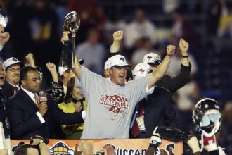 Head coach Jon Gruden of the Tampa Bay Buccaneers holds up the Lombardi Trophy as he celebrates the Super Bowl XXXVII victory over the Oakland Raiders on January 26, 2003 at Qualcomm Stadium in San Diego, California.